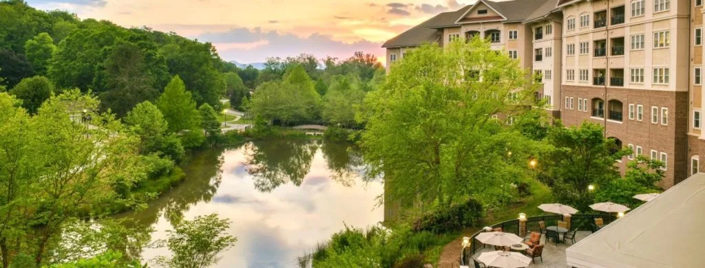 Hotel overlooking river and lush green trees