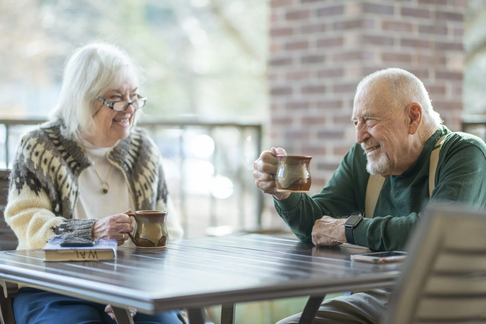 senior couple enjoying coffee together outdoors