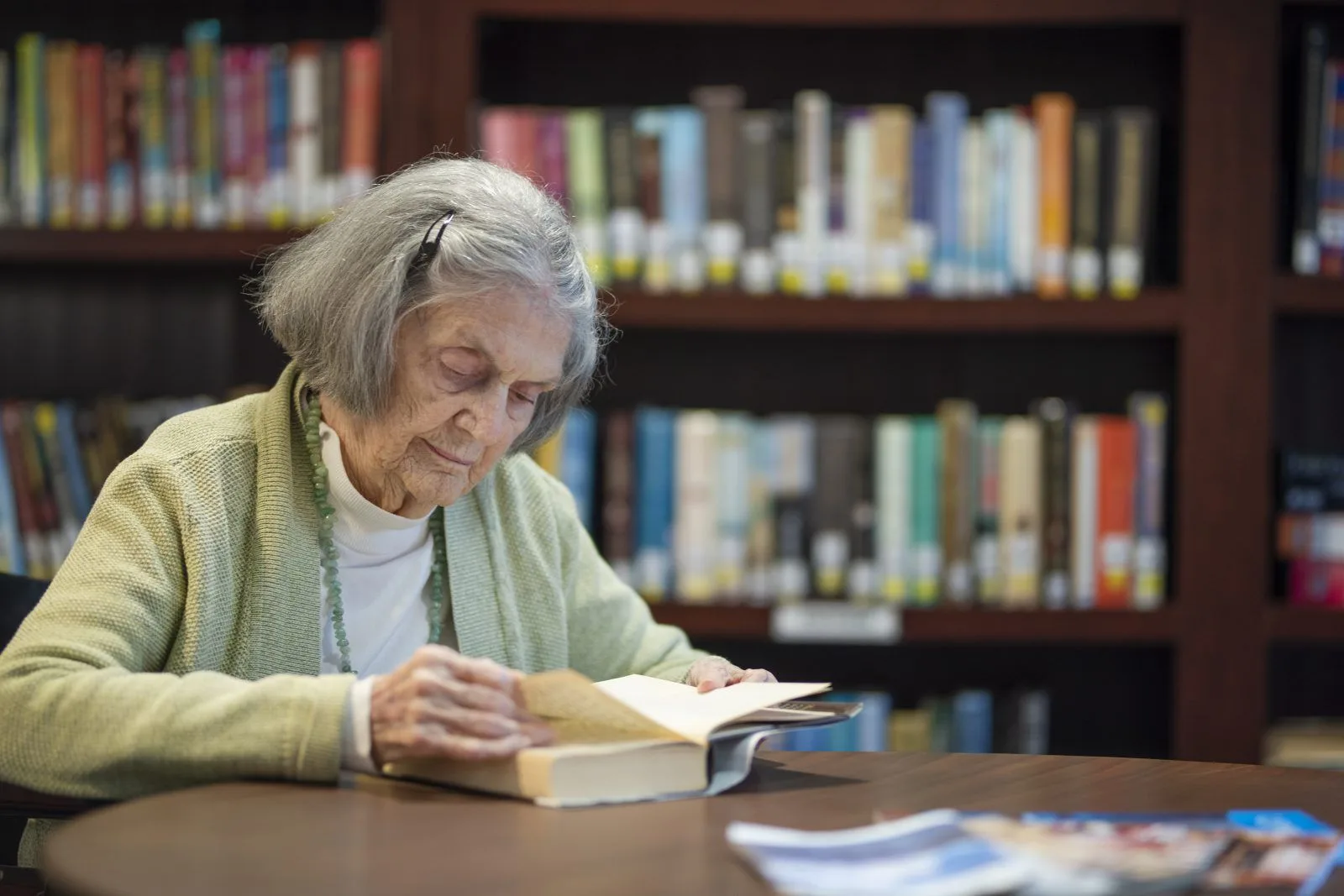 woman reading a book in library