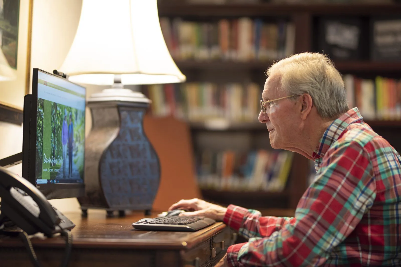 Man using desktop computer in library
