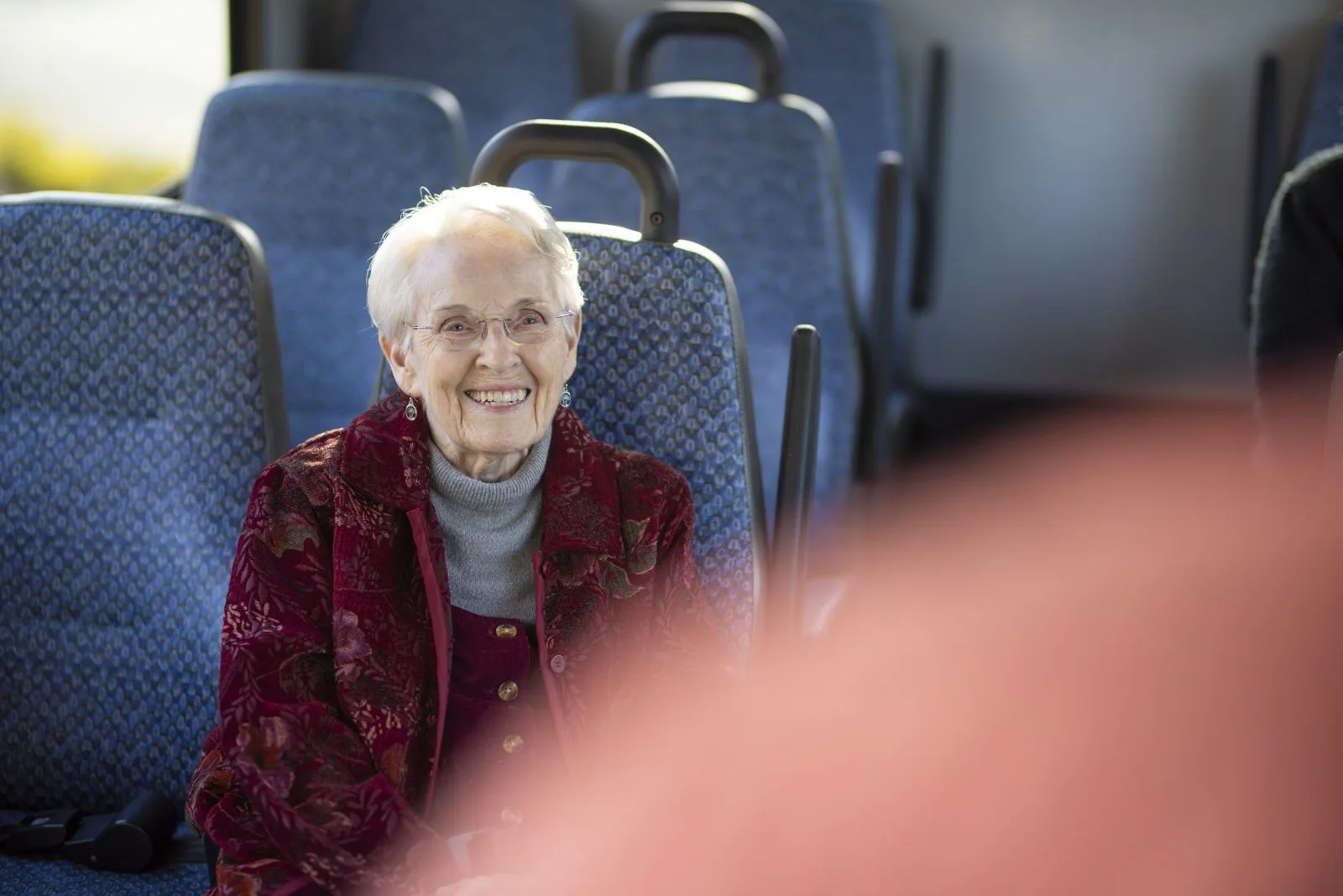 Smiling woman sitting on a bus seat