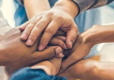 Group of hands showing unity and teamwork