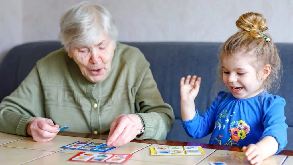 Grandmother and granddaughter playing a card game together