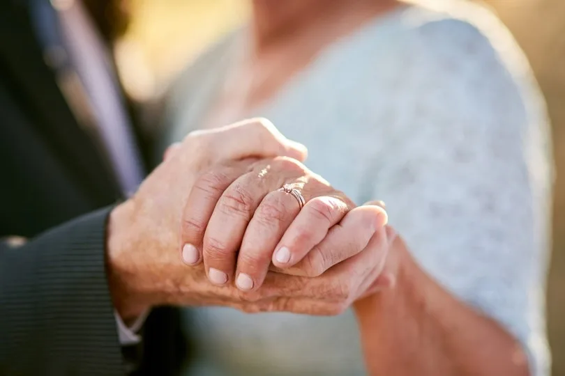 couple holding hands lovingly outdoors